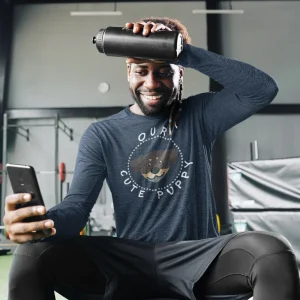 Rottweiler long sleeve shirt mockup of a man checking his phone at the gym
