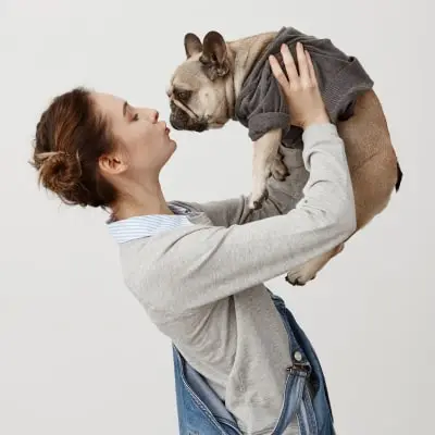 Do Pugs Bark A Lot? How To Control This Disturbing Behavior 2 Young girl being love with her dog display affection