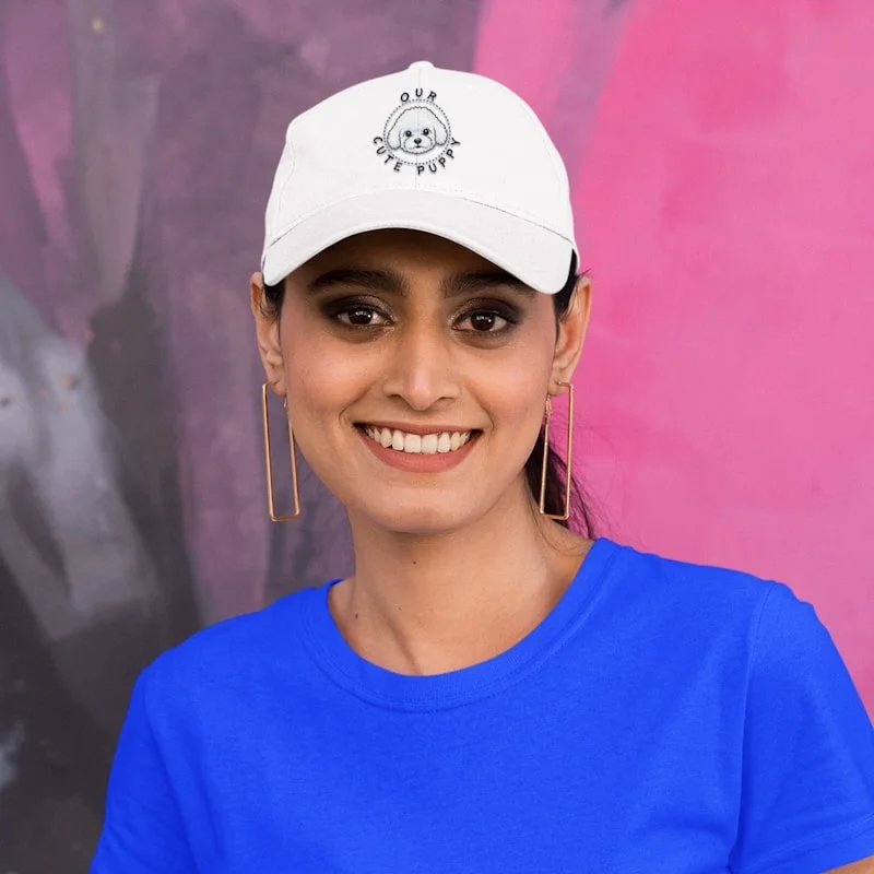 Bichon Dad Hat - Classic Dad Cap 1 Bichon dad hat mockup featuring a smiling woman posing against a colorful wall