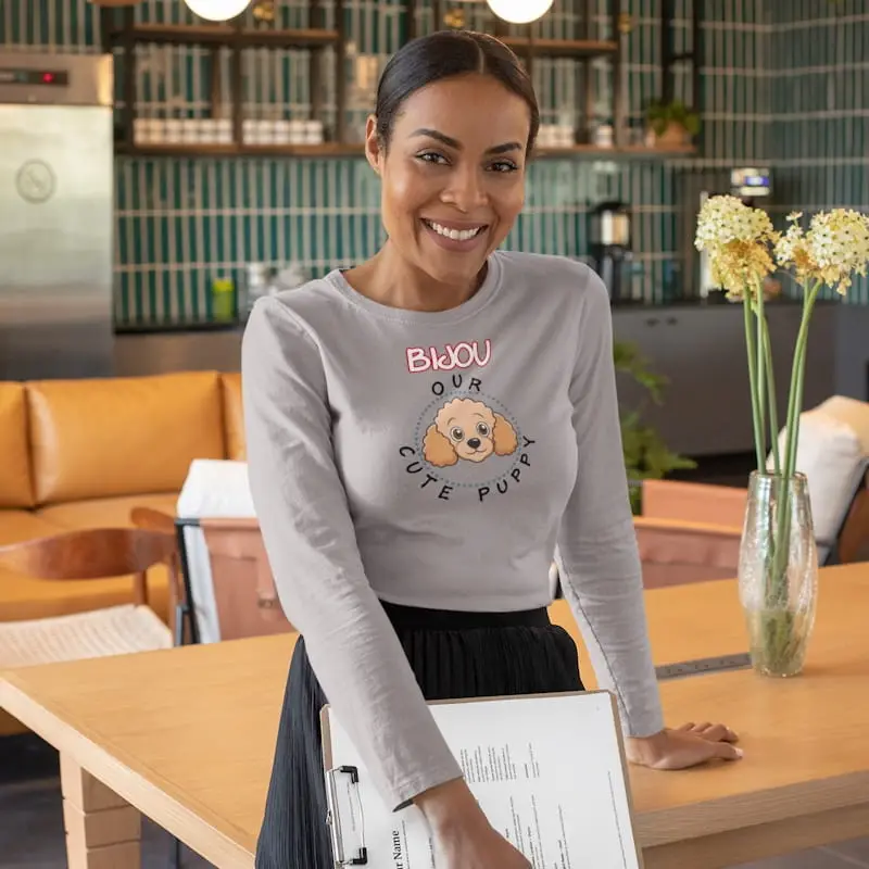Exclusive Poodle Long-Sleeve Shirt, Unisex 3 A middle-aged woman wearing a poodle long-sleeve shirt at a modern office