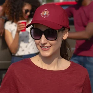 A woman at a tailgate party wearing an embroidered Beagle dad hat
