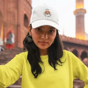 Our Cute Puppy 4 A woman wearing a Beagle dad hat and a yellow sweatshirt