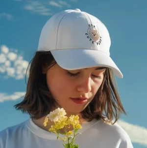 Our Cute Puppy 10 Pomeranian dad hat mockup of a woman posing with flowers against the sky