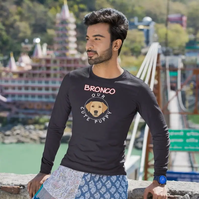 Genuine Labrador Long-Sleeve Shirt, Unisex 5 Labrador long-sleeve shirt mockup featuring a man posing by a rock bridge